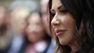 Homeland Security Secretary Kristi Noem looks down while sitting in Donald Trump's Cabinet meeting