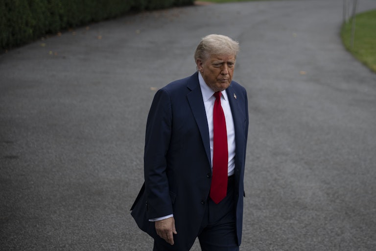 Donald Trump purses his lips while walking outside the White House