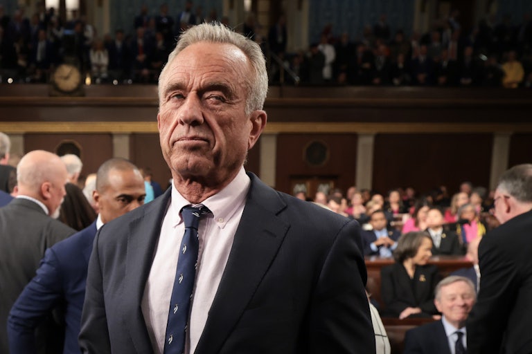 Robert F. Kennedy Jr. looks to the side while standing in Congress during Donald Trump’s address to a joint session