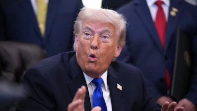 Donald Trump gestures while speaking