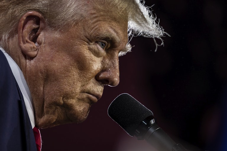 Donald Trump stands at a microphone