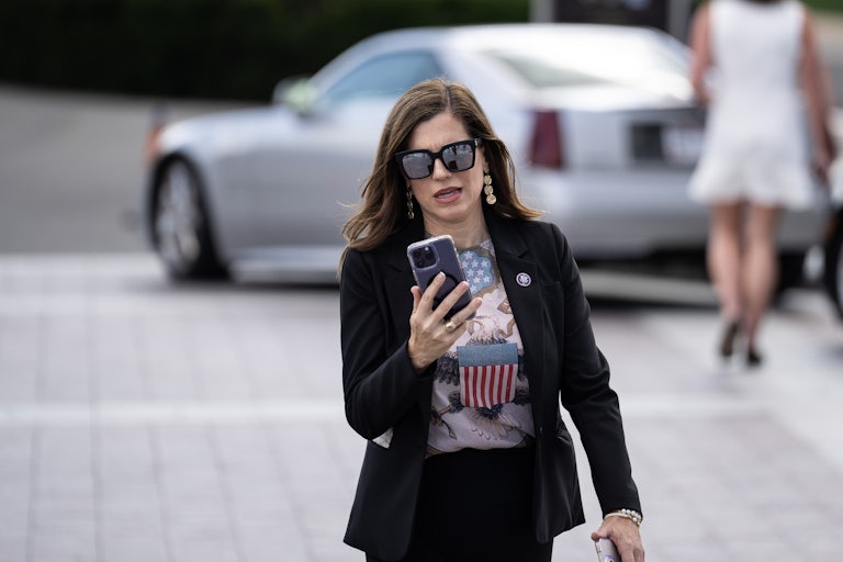Nancy Mace looks at her phone as she walks