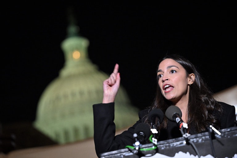 Alexandria Ocasio-Cortez gestures as she speaks