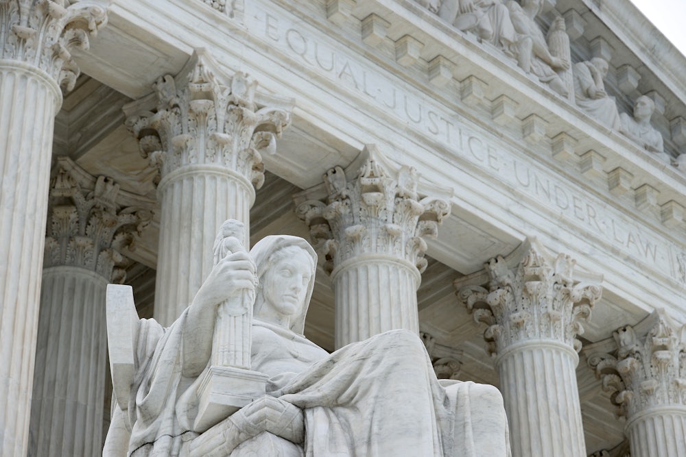 The statue Contemplation of Justice by sculptor James Earle Fraser stands on the steps of the U.S. Supreme Court in Washington, D.C.