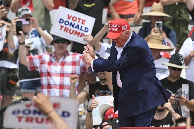 Donald Trump mimics a golf swing
