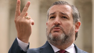 A close-up of Senator Ted Cruz gesturing with two fingers.
