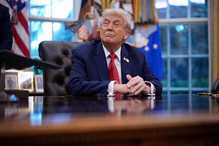 Donald Trump sits at his desk in the White House