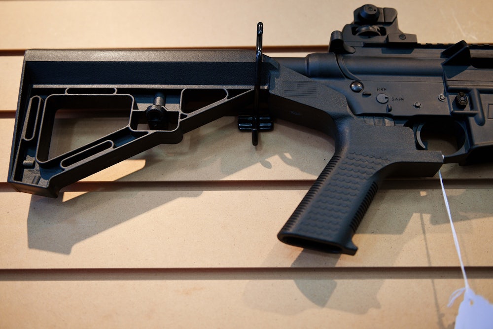 A bump stock installed on an AR-15 rifle