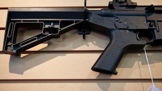 A bump stock installed on an AR-15 rifle