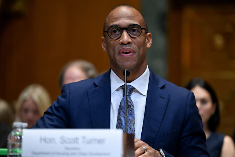 Housing and Urban Development Secretary Scott Turner speaks while sitting in a Senate committee hearing