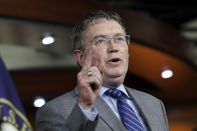 Representative Thomas Massie speaks in the Capitol while pointing a finger.