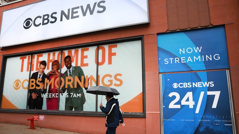 People walk by the CBS Broadcast Center in Manhattan. CBS News has faced a series of controversies in recent weeks, chief among them editor-in-chief Bari Weiss’s decision to abruptly pull a 60 Minutes story that dealt with Venezuelan migrants to the U.S., whom the Trump administration deported to CECOT, the notorious prison in El Salvador.
