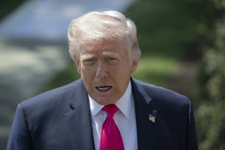 Donald Trump speaks to reporters outside the White House