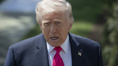 Donald Trump speaks to reporters outside the White House