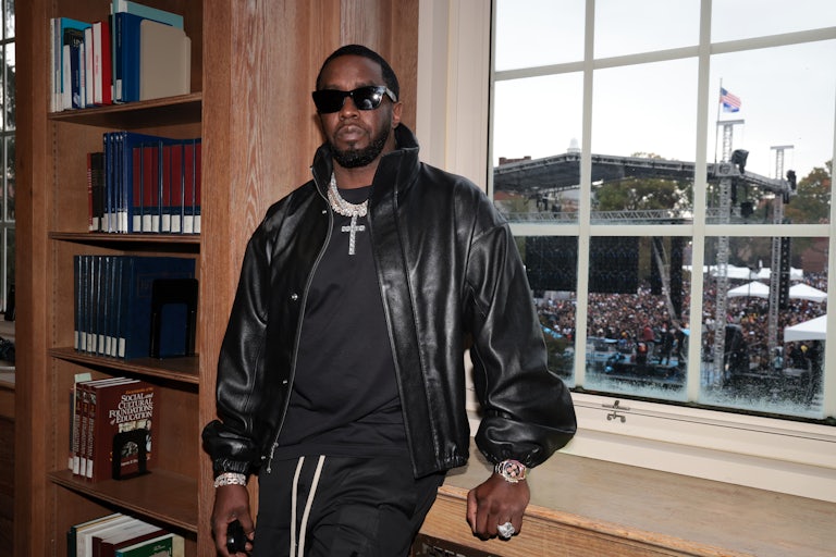 Sean "Diddy" Combs leans against a window ledge