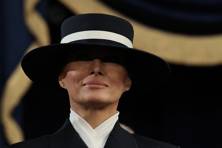 Melania Trump's eyes are in shadow thanks to the large brim on the hat she wore to Donald Trump’s second inauguration.