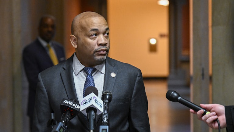 Carl Heastie speaks into microphones at a podium.