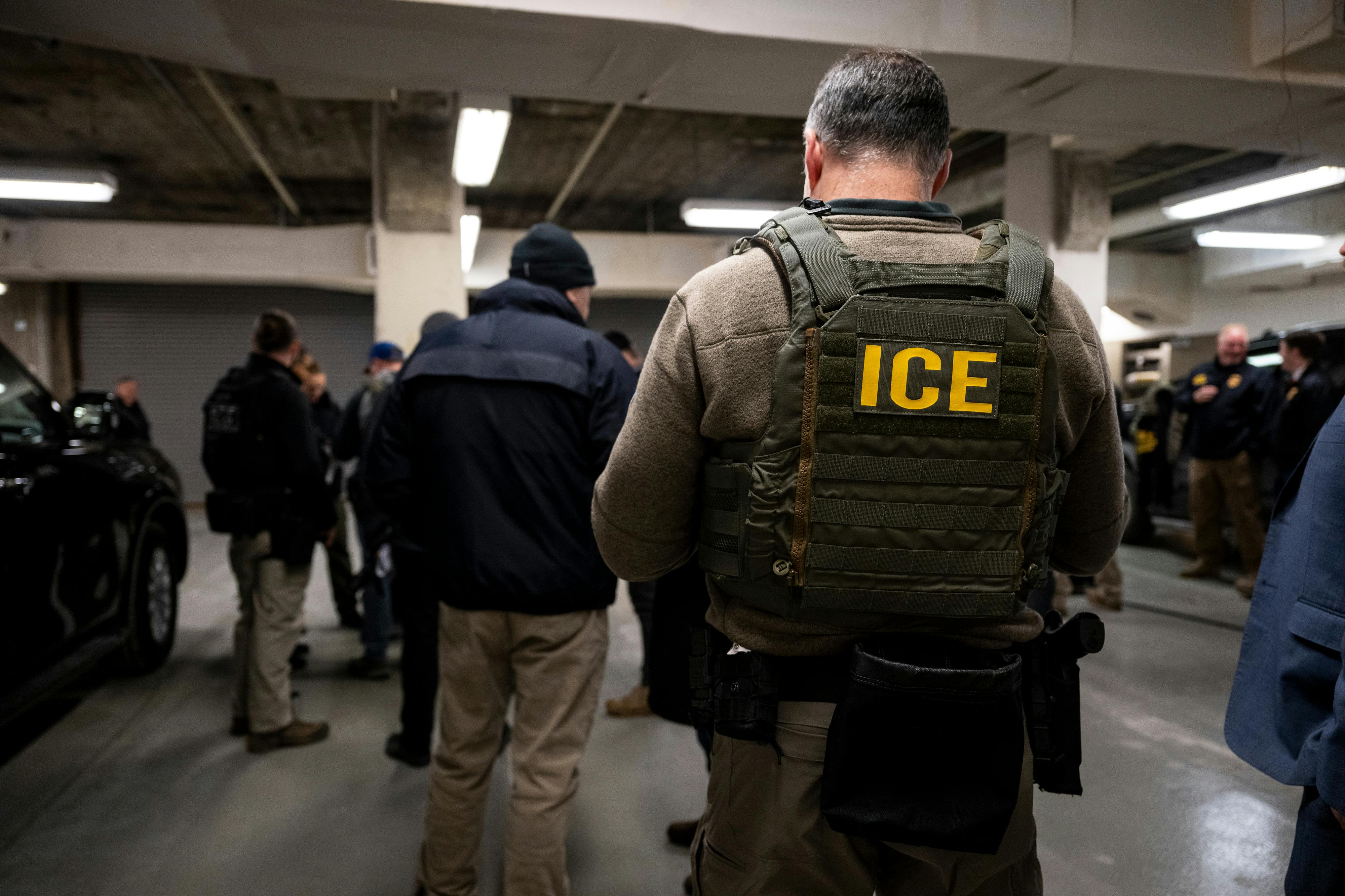 ICE agents in a parking lot