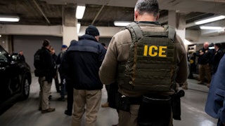 ICE agents in a parking lot