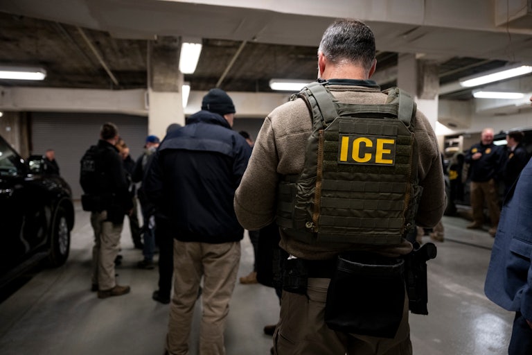 ICE agents in a parking lot