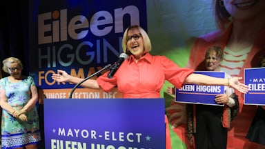 Miami Democratic Mayor-Elect Eileen Higgins holds her arms out to the side and speaks at a podium
