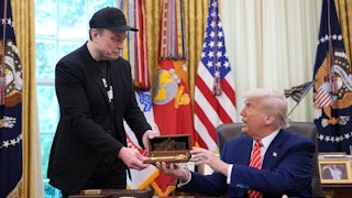 Donald Trump, seated behind his desk in the Oval Office, hands Elon Musk (standing above him) a golden key.