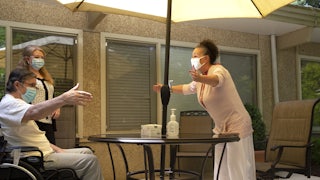woman greets her husband at a nursing home