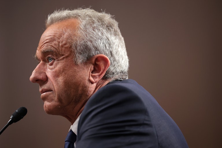 Robert F. Kennedy Jr. sits at a table during his Senate confirmation hearing