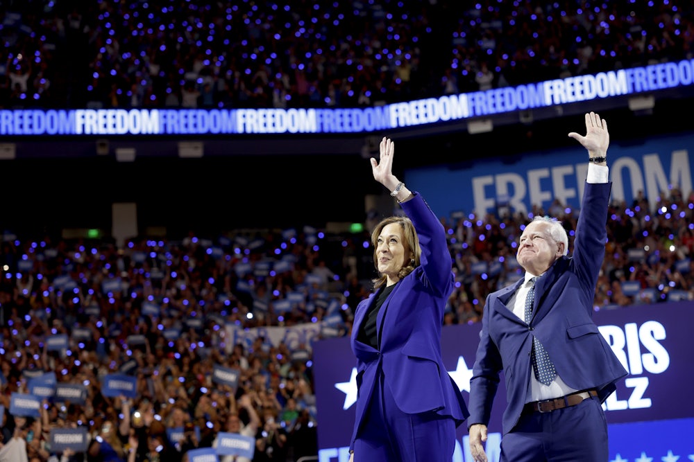 Kamala Harris and Tim Walz walk onstage for a campaign rally at the Fiserv Forum in Milwaukee, Wisconsin.