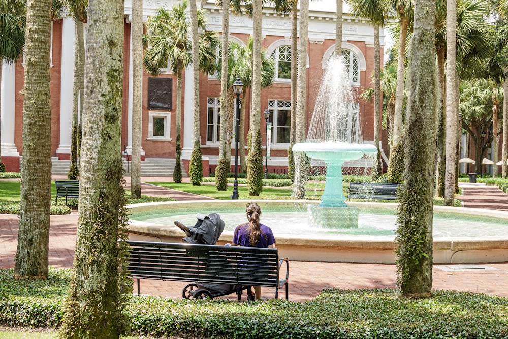 Deland, Florida, Stetson University campus, mother with child admiring fountain.