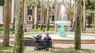 Deland, Florida, Stetson University campus, mother with child admiring fountain.