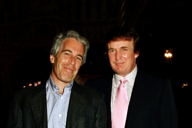 Jeffrey Epstein and Donald Trump smile while standing next to one another. Trump places his hand on Epstein's shoulder.