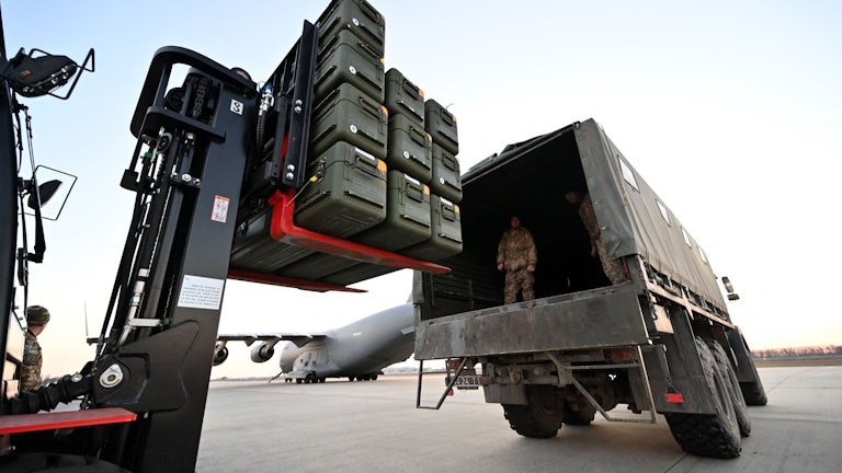 Ukrainian soldiers load U.S.-made Stinger missiles onto a truck at Boryspil Airport in Kyiv