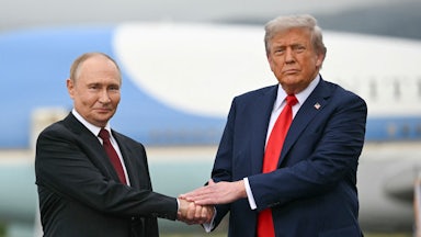 Russian President Vladimir Putin and Donald Trump shake hands