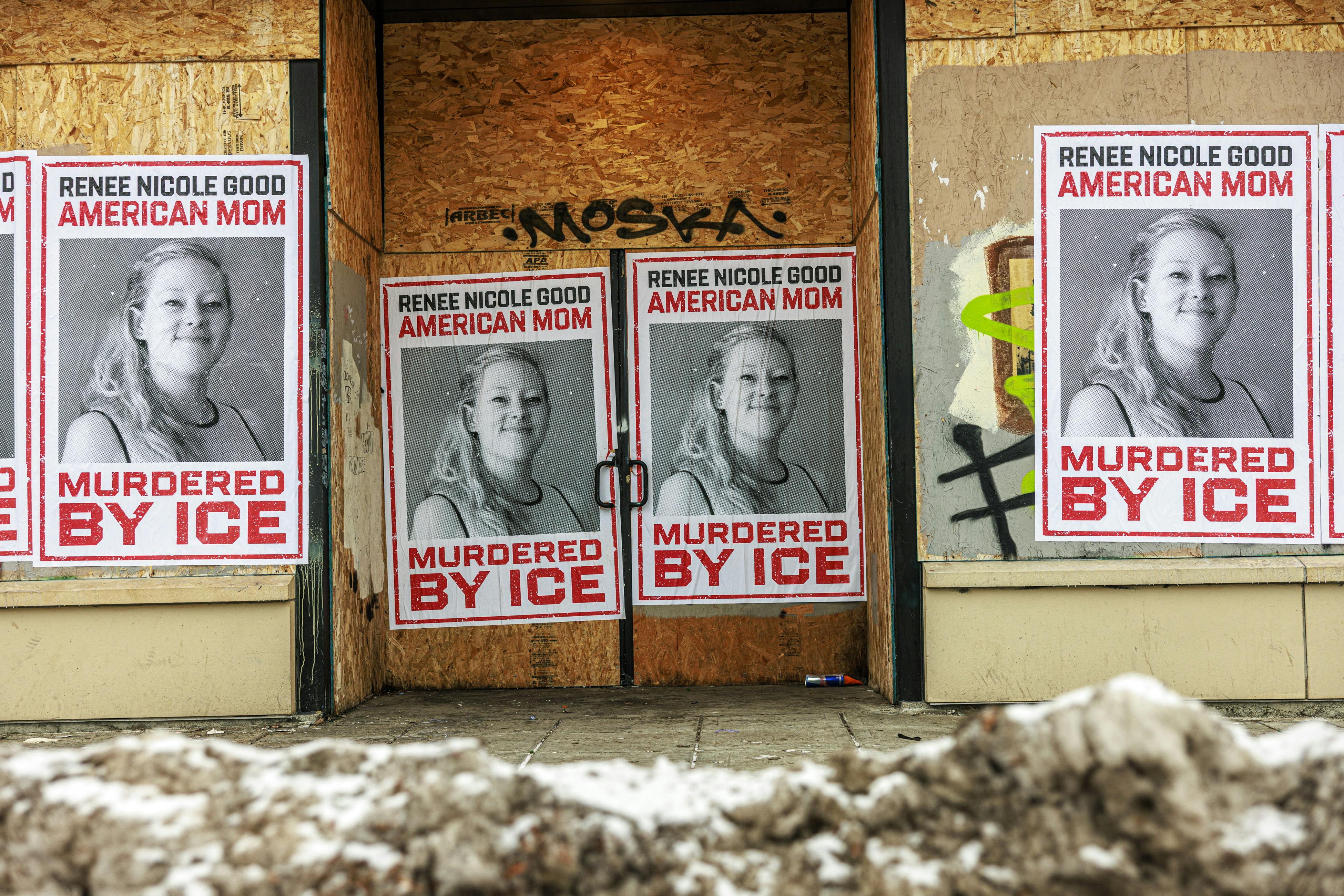 Psosters on a boarded up store that read "Renee Nicole Good American Mom Murdered by ICE" and include a photo of Goodo smiling.