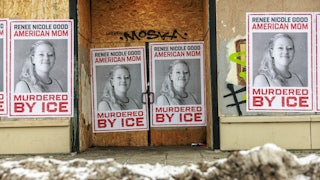 Psosters on a boarded up store that read "Renee Nicole Good American Mom Murdered by ICE" and include a photo of Goodo smiling.