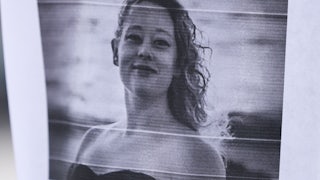 Paper with black and white photo of Renee Good