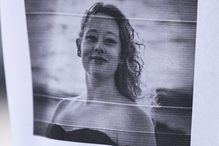 Paper with black and white photo of Renee Good