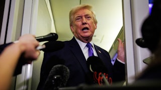 Donald Trump answers questions aboard Air Force One.