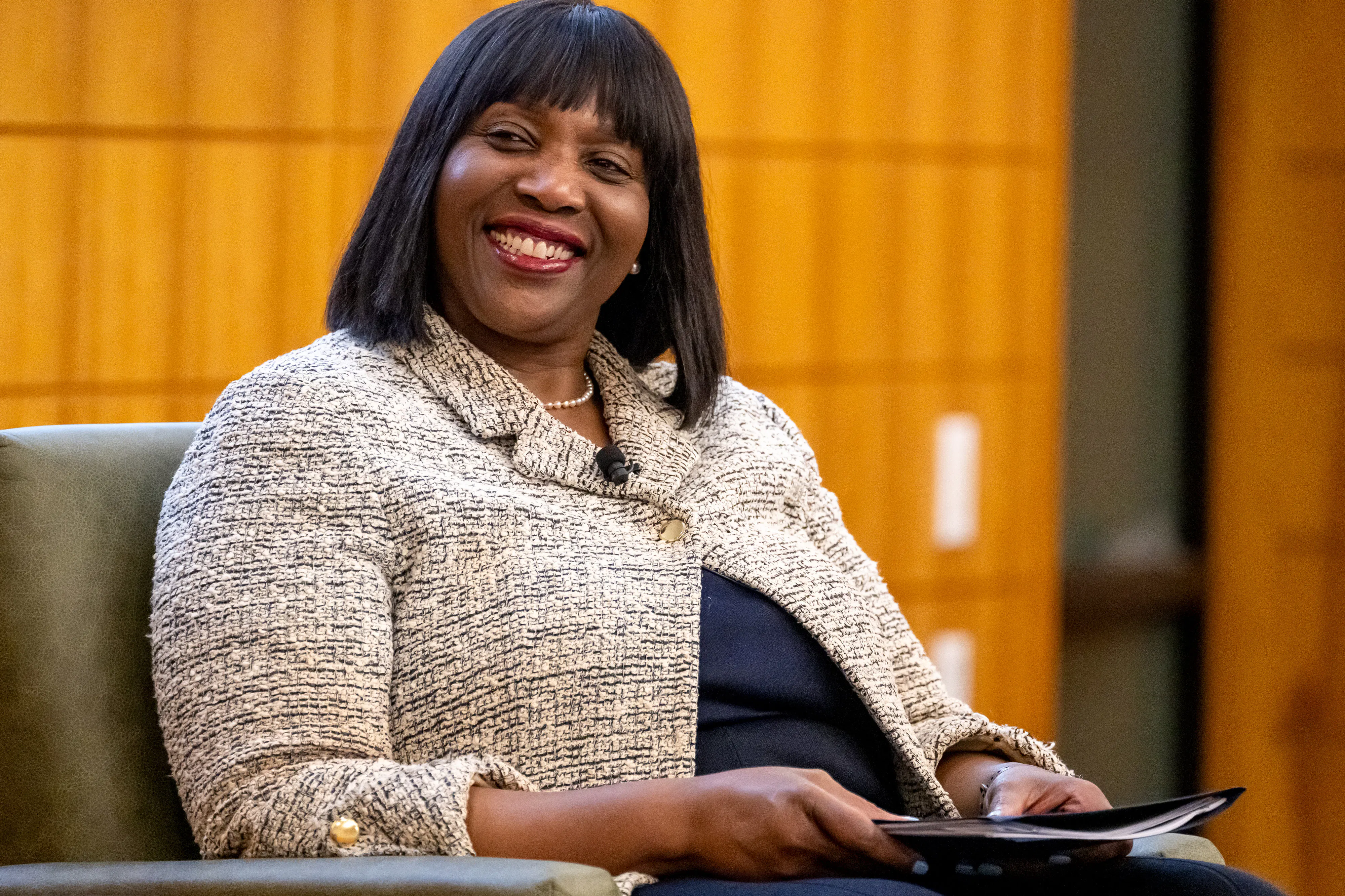 Lisa Cook, governor of the U.S. Federal Reserve, smiles at a panel 