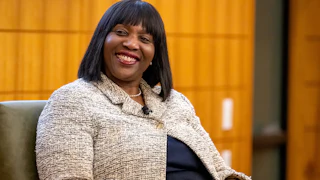 Lisa Cook, governor of the U.S. Federal Reserve, smiles at a panel