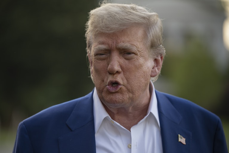 Donald Trump speaks to reporters outside the White House
