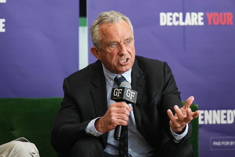 Robert F. Kennedy Jr. sits and speaks into a microphone