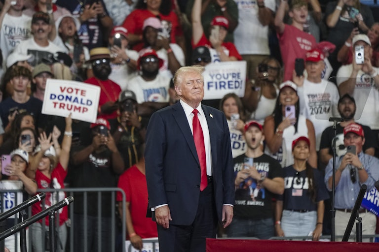 Donald Trump stands onstage at a campaign rally