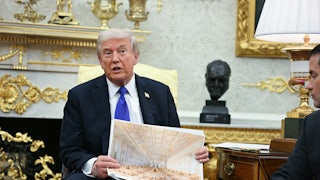 Donald trump holds an architectural rendering of the interior of the white house ballroom