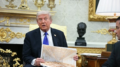 Donald trump holds an architectural rendering of the interior of the white house ballroom