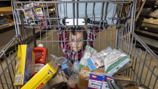 Royce Rasmussen, 8, mans a grocery cart at the store with his mother as they shop with limited Supplemental Nutrition Assistance Program (SNAP) benefits in Idaho Falls, Idaho. More than 130,000 Idahoans receive SNAP benefits.