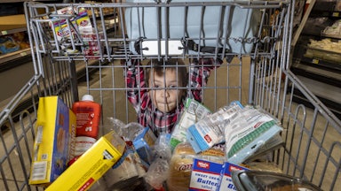 Royce Rasmussen, 8, mans a grocery cart at the store with his mother as they shop with limited Supplemental Nutrition Assistance Program (SNAP) benefits in Idaho Falls, Idaho. More than 130,000 Idahoans receive SNAP benefits.