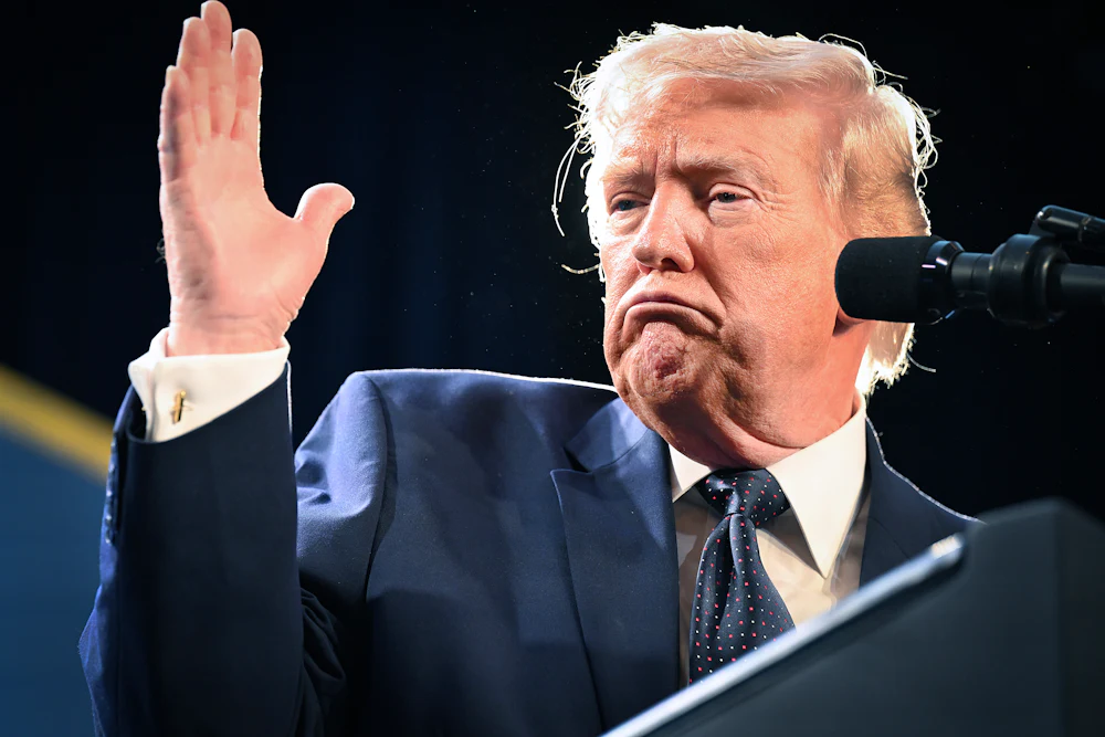 Donald Trump raises right hand while frowning