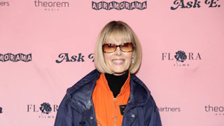 E. Jean Carroll smiling in front of a backdrop